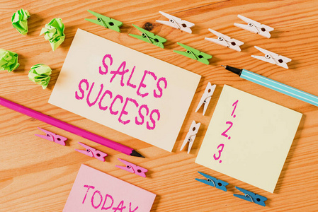 彩色衣夾放在木制地板中央的空矩形方形提醒紙條周圍。有凹槽和槽的木頭。辦公用品,鉛筆和鋼筆。